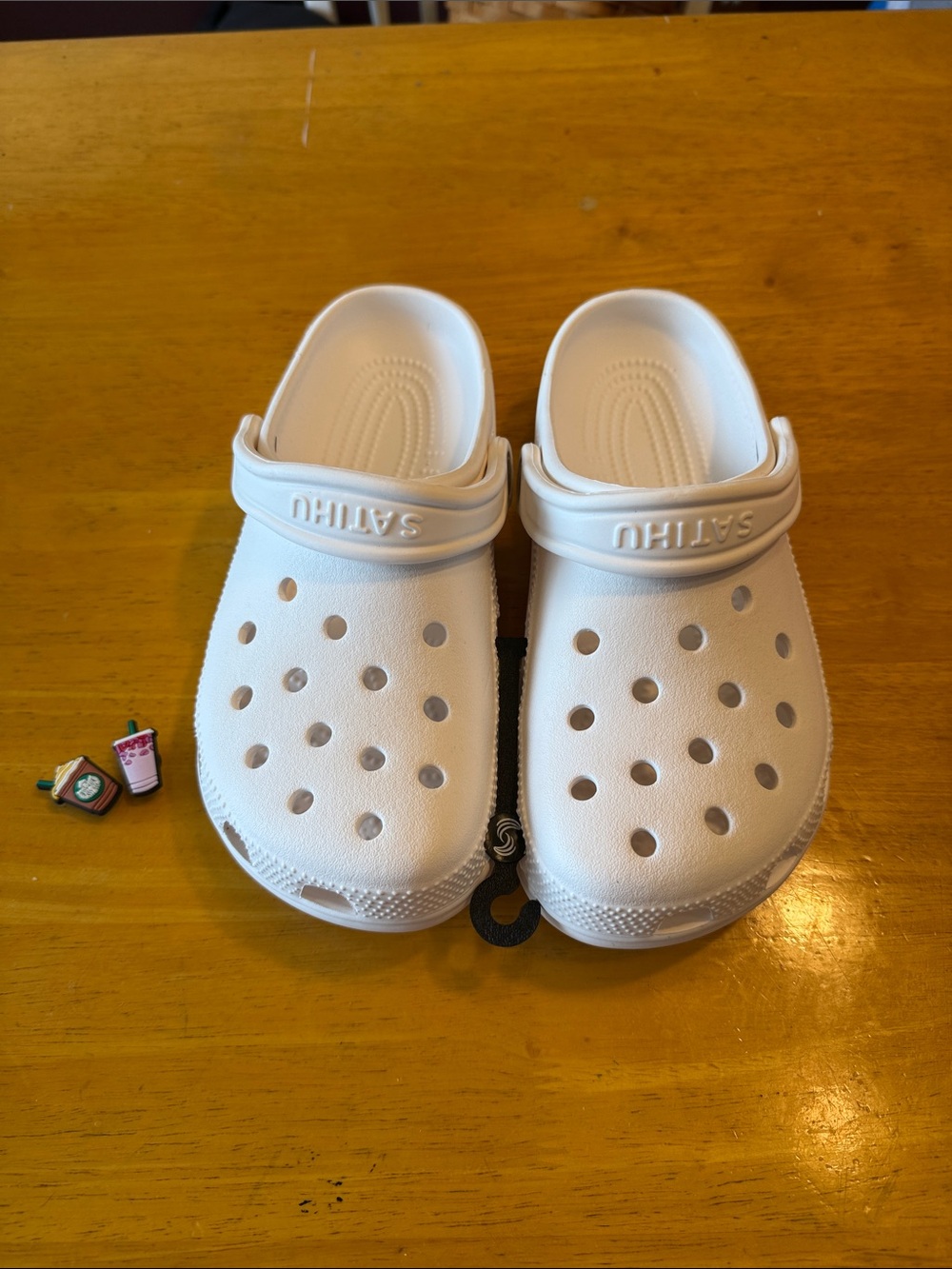 White clogs. Women’s size 8. Men’s size 6. New in package w/ Starbucks charms